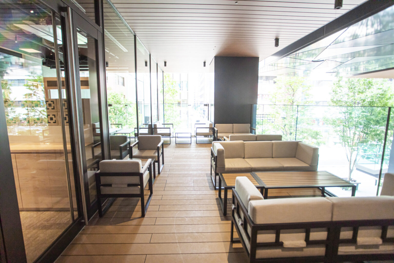 A wide view of the terrace seating beside the windows and greenery